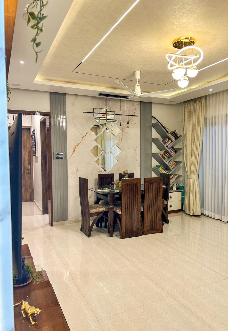 Luxury dining area interior with ceiling lighting and integrated shelving by Doric & Co. Pune